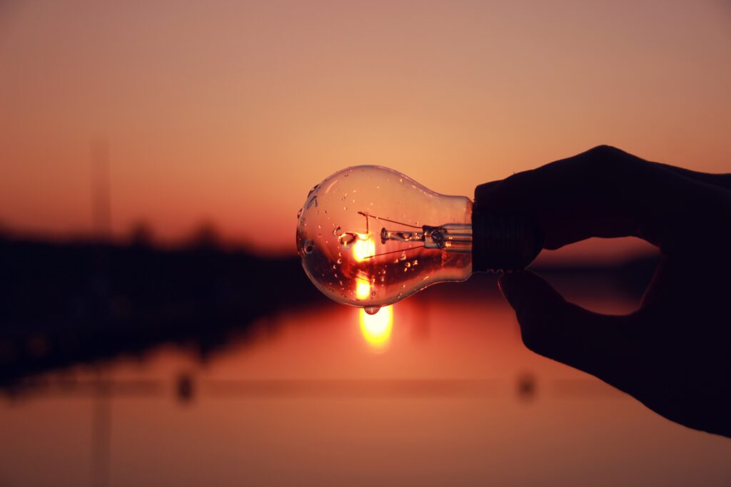 Looking at a sunset over the water through a lightbulb.