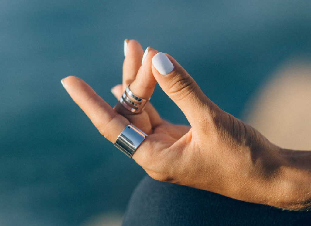 A hand in the meditative position, as if you were meditating during your morning routine.