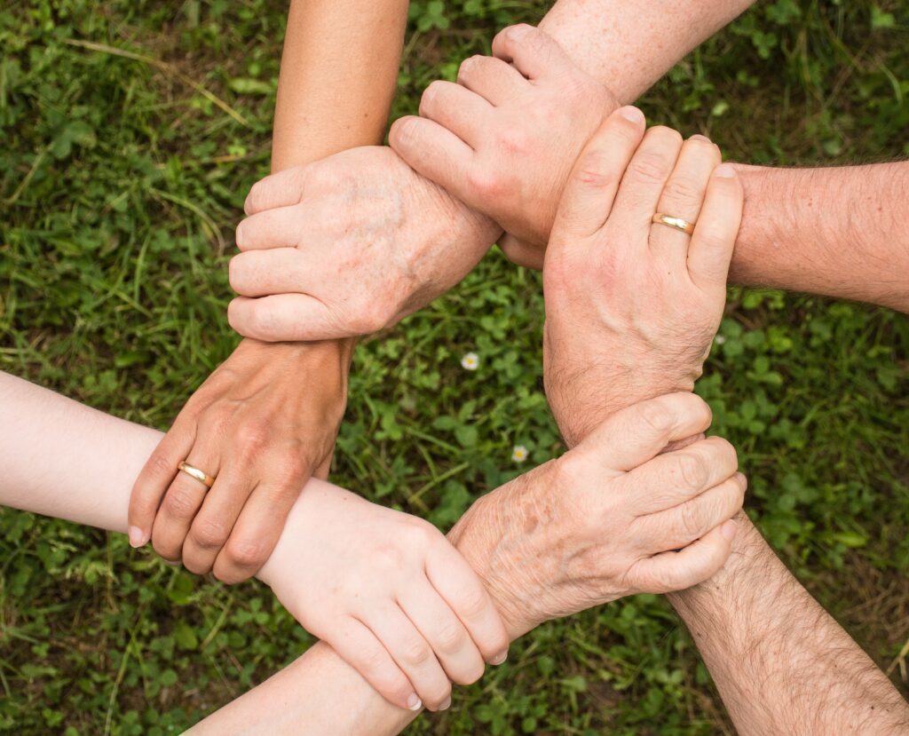 Hands forming a circle, as if helping each other to live your best life and thrive.