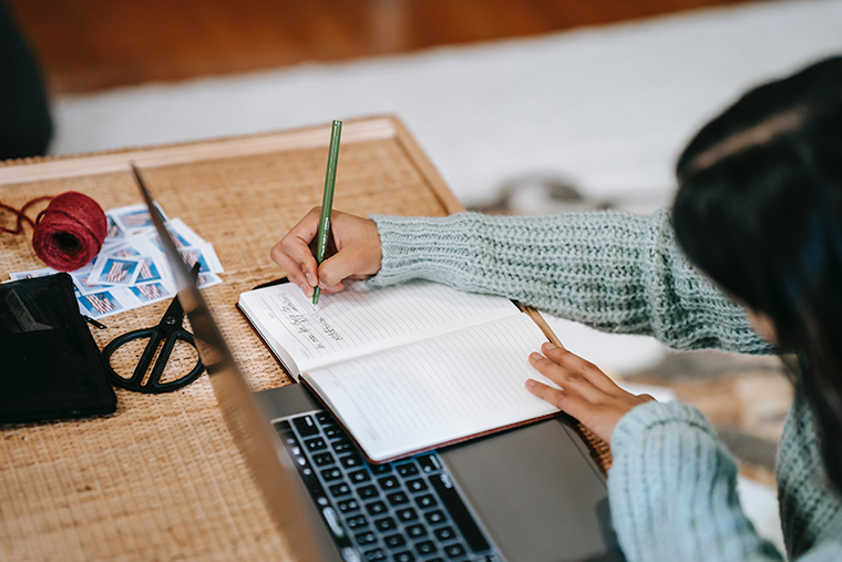 A woman immersing herself in her journal.