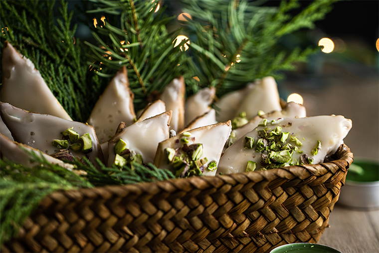 Homemade cookies in a basket decorated with greenery make a great gift.